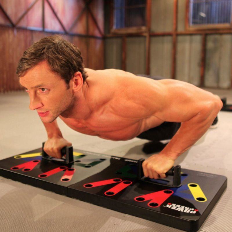 Man using the Power Press push up board in a gym setting